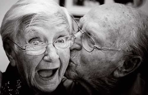 Elderly couple kissing